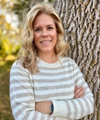 Becca Kall posing outdoors smiling